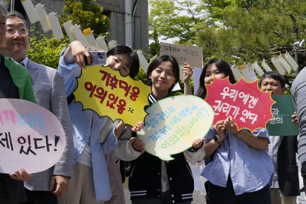 Young activists taking a selfie outside the Korean Constitutional Court on April 23, 2024.