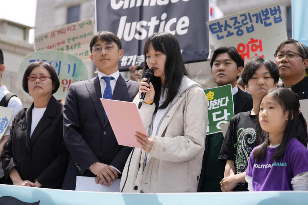 Plaintiff speaking at a press conference ahead of the first public hearing held on April 23, 2024.