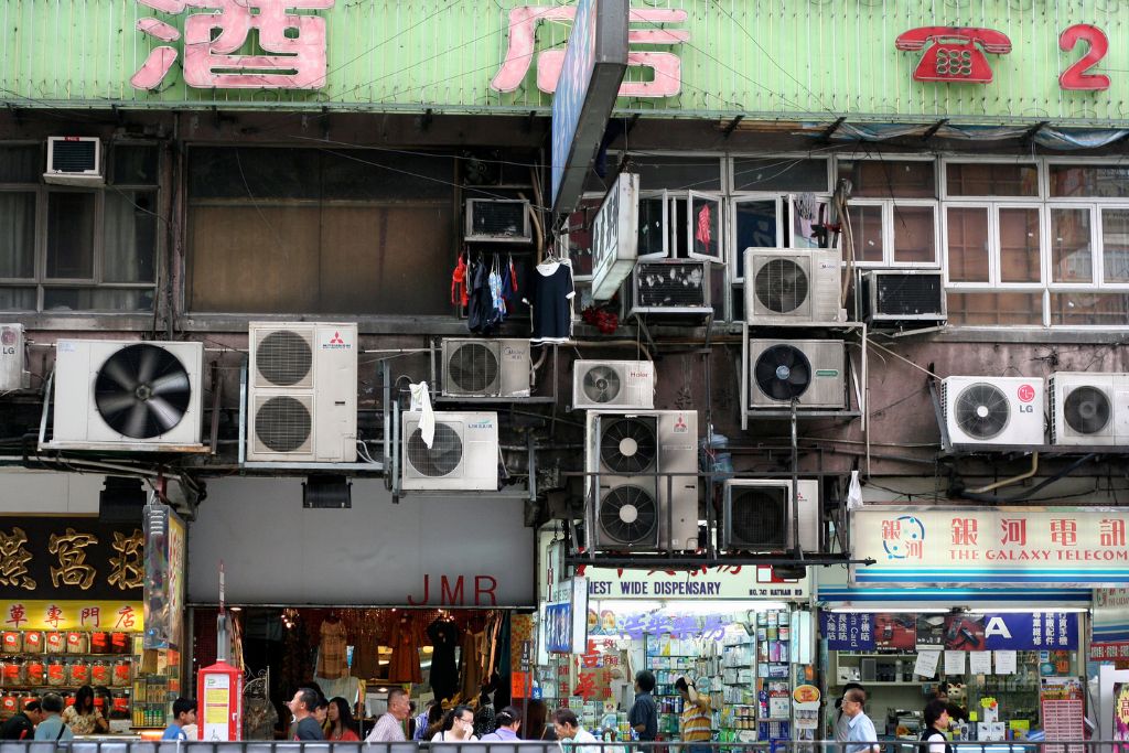 Air conditioning units hang from the side of a building in Kowloon, Hong Kong.