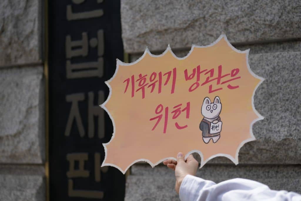 A handmade sign reading "Neglecting the climate crisis is unconstitutional