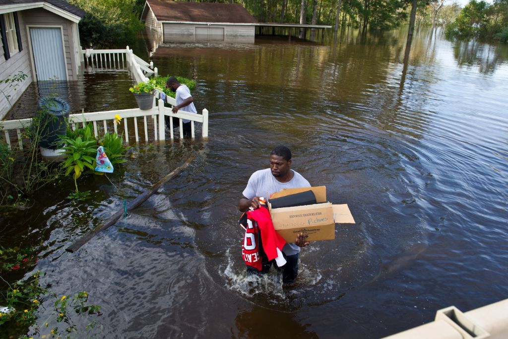 Former NFL player Robert Geathers retrieves any possessions not destroyed by the flood at his family home in Brown's Ferry near Georgetown, South Carolina, Oct. 10, 2015.